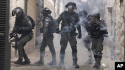 Palestinians shoot fireworks at Israeli police in the Old City of Jerusalem, April 17, 2022. 