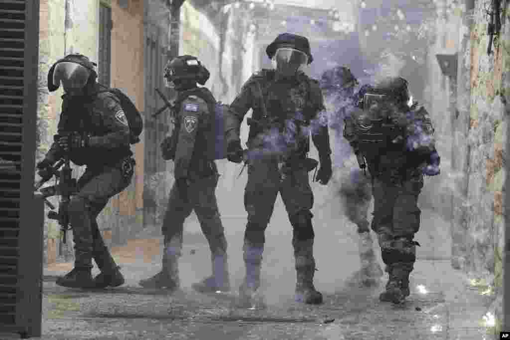 Palestinians shoot fireworks at Israeli police in the Old City of Jerusalem.&nbsp;Israeli police clashed with Palestinians outside Al-Aqsa Mosque after police cleared Palestinians from the sprawling compound to facilitate the routine visit of Jews to the holy site and accused Palestinians of stockpiling stones in anticipation of violence.&nbsp;