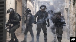 Palestinians shoot fireworks at Israeli police in the Old City of Jerusalem, April 17, 2022. 