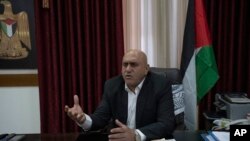 Jenin's governor, Akram Rajoub, talks to reporters at his office, in the West Bank city of Jenin, April 12, 2022. Two Palestinian men were injured Monday near Jenin, the latest incident in a wave of violence between Israelis and Palestinians.
