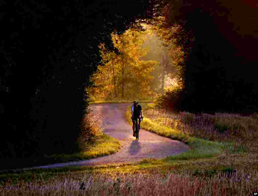 A man rides his bike on a small road on the outskirts of Frankfurt, Germany.
