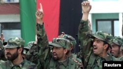 FILE - Afghan soldiers shout "Allahu akbar" (God is great) during their graduation ceremony in Kabul, March 27, 2003. 