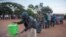 FILE - People queue to wash their hands to protect against the coronavirus before lining up to vote at a polling station, in Lilongwe, Malawi, June 23, 2020. The COVID pandemic has led to a spike in suicides in the southeastern African country. 