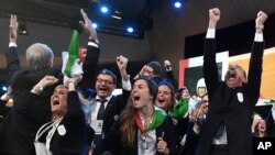 Mayor of Milan Giuseppe Sala, right, and members of the Milan-Cortina delegation celebrate after winning the bid to host the 2026 Winter Olympic Games, in Lausanne, Switzerland, June 24, 2019.