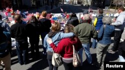 Sarah Orr (L) hugs her sister Heather (R) at a memorial to the victims of the Boston Marathon bombings near the scene of the blasts on Boylston Street in Boston, Massachusetts, Apr. 21, 2013.