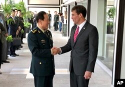 FILE - Chinese Defense Minister Wei Fenghe, left, greets U.S. Defense Secretary Mark Esper in Bangkok, Thailand, Nov. 18, 2019.