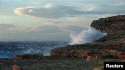 Self-proclaimed royal super-fan John Loughrey reads a tabloid newspaper in London.