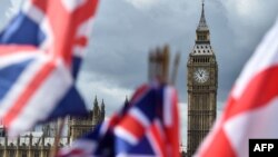 National flags flutter near the The Elizabeth Tower, commonly referred to as Big Ben, in central London, June 9, 2017. 