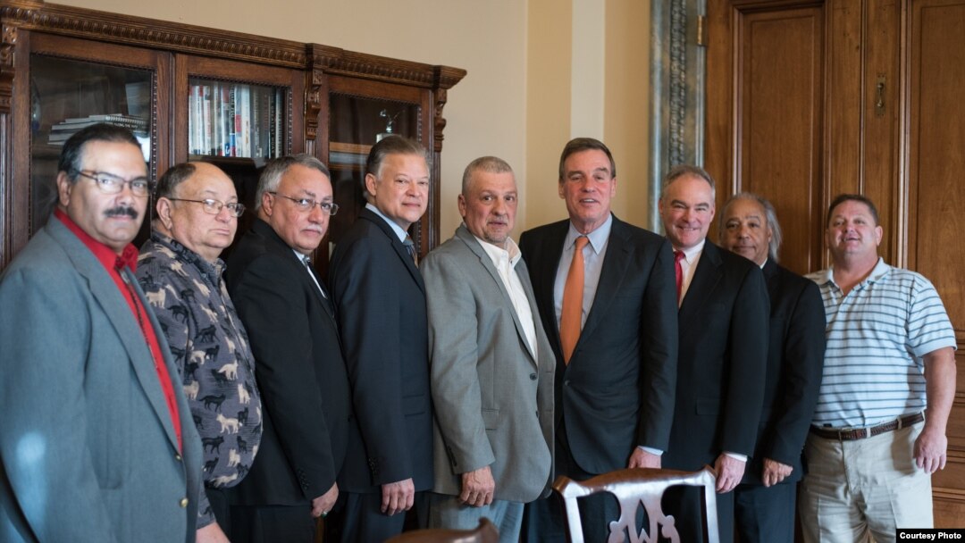 U.S. Senators Tim Kaine and Mark Warner, Democrats from Virginia, pose with seven Virginia tribal chiefs ahead of final passage of bill granting recognition to six Virginia Indian tribes, January 11, 2017. President Donald Trump signed the new law Januar