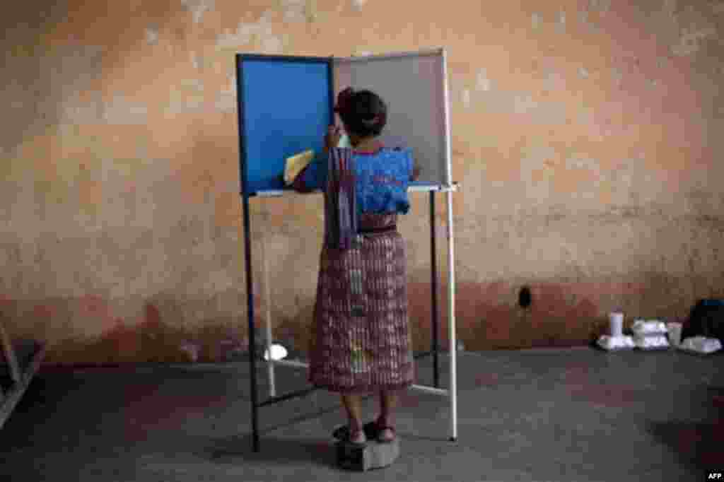A woman casts her vote during the country's general elections in San Lucas Toliman, Guatemala, Sunday, Sept. 11, 2011. Polls have indicated that Otto Perez Molina of the Patriotic Party, a former army general, is the leading candidate in Sunday's electio