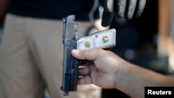 FILE - A gun is surrendered during a buyback event at Los Angeles Sports Arena in Los Angeles, California. May 31, 2014. A federal appeals court ruled Thursday that U.S. citizens do not have a constitutional right to carry concealed weapons in public.