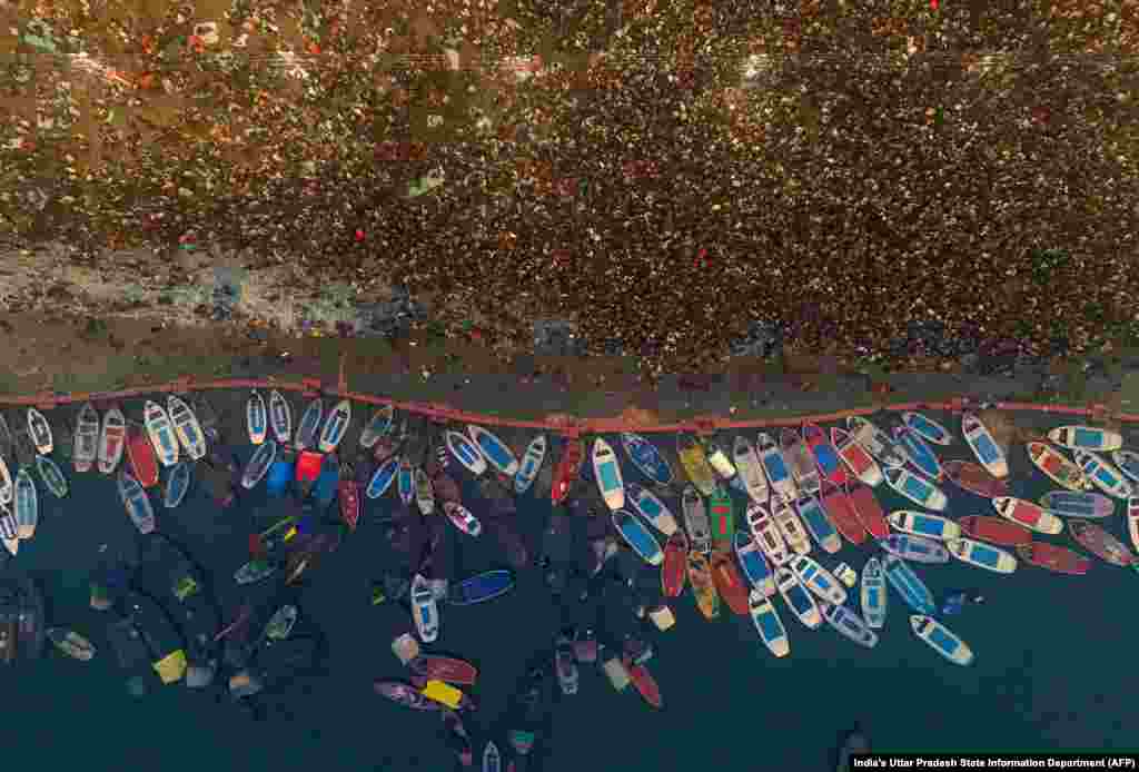 Hindu pilgrims gather to take a holy dip in the sacred waters of Sangam, the confluence of Ganges, Yamuna and mythical Saraswati rivers, during the Maha Kumbh Mela festival in Prayagraj in India.