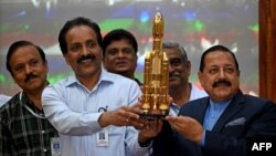 Indian Space Research Organisation (ISRO) chief S. Somanath (2L) and Minister of State for the Ministry of Science and Technology Jitendra Singh (R) hold a model of spacecraft Chandrayaan-3 during a press conference, after its launch from the Satish Dhawa