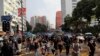 Demonstrators wearing face masks walk down a street during a protest in Hong Kong, Oct. 12, 2019.