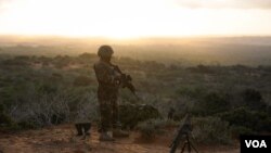 Seorang tentara berdiri di atas bukit mengawasi kota Barawe yang dikuasai militan al-Shabab di Somalia.