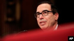 FILE - Treasury Secretary Steven Mnuchin testifies on Capitol Hill in Washington, July 26, 2017, before the Senate Appropriations subcommittee on the fiscal 2018 federal budget. 