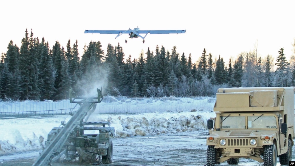 In this Jan. 30, 2014 photo, an unmanned aircraft flies at Joint Base Elmendorf-Richardson in Anchorage, Alaska. U.S. military bases in the Arctic and sub-Arctic are not taking steps against climate change, the Pentagon's watchdog office said recently. (AP Photo/Dan Joling, File)