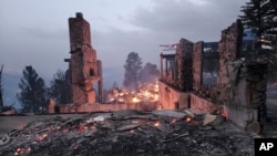 The remains of a home left after a wildfire spread through the Village of Ruidoso, New Mexico, April 13, 2022.