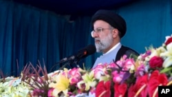 FILE - In this photo released by the Iranian presidency, President Ebrahim Raisi reviews troops on National Army Day, April 18, 2022, outside Tehran, Iran. Raisi warned that Israel would be targeted by his country's armed forces if it made "the tiniest move" against Iran.