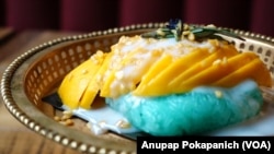 Mango sticky rice is served on Thai traditional golden tray in Sisters Thai Alexandria restaurant in Alexandria, Virginia