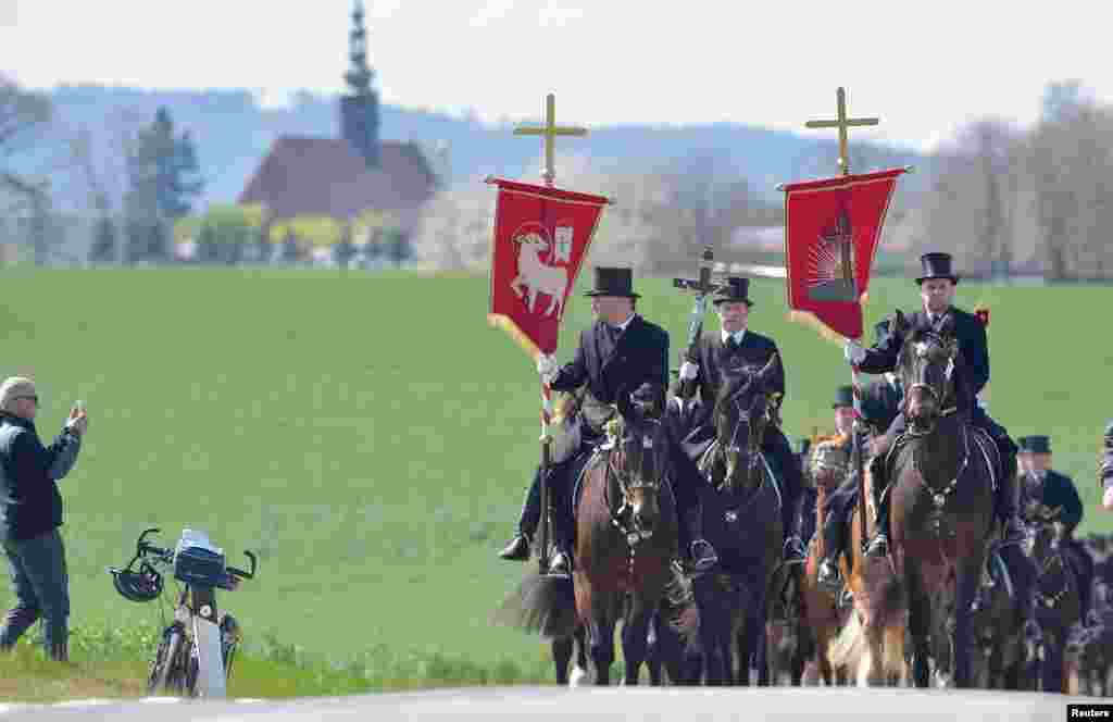 Men of Slavic ethnic minority of Sorbs dressed in black tailcoats ride decorated horses during an Easter riding procession near Panschwitz-Kuckau, eastern Germany.