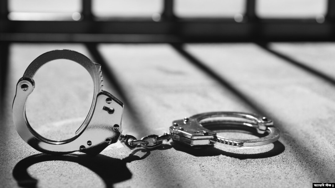 Handcuff and prison bars