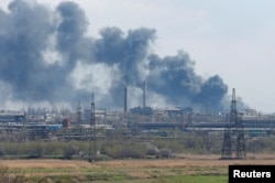 Smoke rises above a plant of Azovstal Iron and Steel Works company during Ukraine-Russia conflict in the southern port city of Mariupol, April 20, 2022.