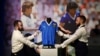 Des artistes posent avec le maillot porté par le footballeur argentin Diego Maradona lors de la Coupe du monde 1986, avant qu'il ne soit mis aux enchères par Sotheby's, à Londres, le 20 avril 2022.
