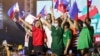 FILE - Former senator Ferdinand "Bongbong" Marcos Jr., center-left, and his running mate Davao City Mayor Sara Duterte, center-right, wave Philippine flags during rally announcing his presidential bid, at the Philippine Arena, Bulacan province, north of Manila.