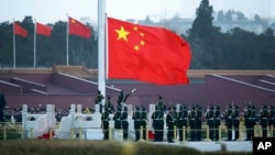 FILE - The Chinese flag is raised at a ceremony on Tiananmen Square in Beijing, March 5, 2016.
