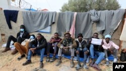 FILE: African migrants are pictured at a United Nations High Commisioner for Refugees (UNHCR) camp in the southern Tunisian port of Zarzis, near the Libyan border, during a protest demanding their resettlement. taken Feb. 14, 2022.