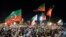 Supporters of ousted Pakistan's prime minister Imarn Khan of Pakistan Tehreek-e-Insaf (PTI) party, hold flags and signs as they gather during a public rally in Peshawar on April 13, 2022.