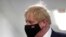 FILE - Britain's Prime Minister Boris Johnson wears a face mask during a visit to Milton Keynes University Hospital in Buckinghamshire, England, Jan. 24, 2022. 