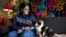 Tara Kramer sits in her apartment with her cat Busy, April 8, 2022, in Des Moines, Iowa. More of the roughly 40 million Americans who get help buying food through the federal SNAP program are seeing their benefits plunge even as the nation struggles with 