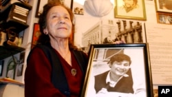 FILE - Mexico's human rights activist Rosario Ibarra de Piedra shows a photo of her son Jesus who disappeared during Mexico's so called "dirty war", Nov. 5, 2003.