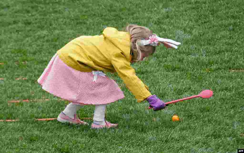 A kid takes part in the annual White House Easter Egg Roll on the South Lawn of the White House in Washington, D.C.