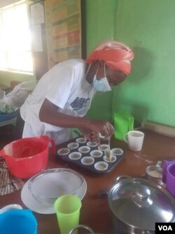 A woman learning to cook cup cakes in Zimbabwe's second largest city, Bulawayo.