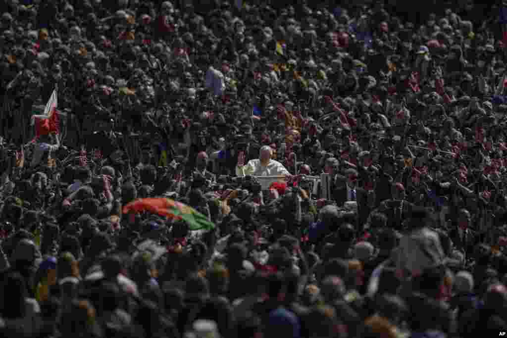 Pope Francis on his popemobile drives through the crowd of faithful at the end of the Catholic Easter Sunday mass he led in St. Peter&#39;s Square at the Vatican.