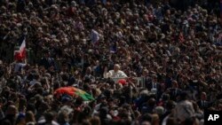 Pope Francis on his popemobile drives through the crowd of faithful at the end of the Catholic Easter Sunday mass he led in St. Peter&#39;s Square at the Vatican.