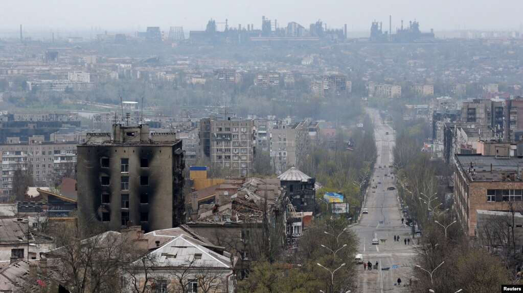 FILE - FILE PHOTO: A view shows damaged buildings, with the Azovstal Iron and Steel Works plant in the background, in the southern port city of Mariupol, Apr. 19, 2022.