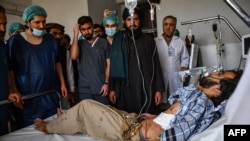 FILE - A wounded Afghan man receives treatment at a hospital after he got injured in a bomb blast at a Shiite Mosque in Mazar-e-Sharif on April 21, 2022.