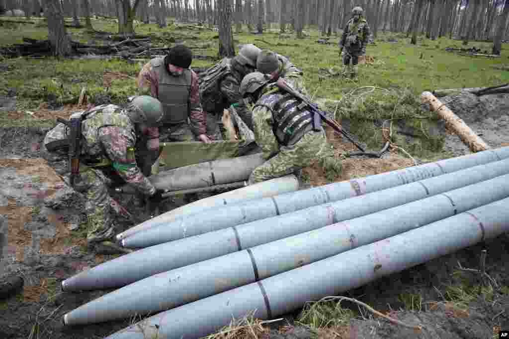 Ukrainian soldiers collect multiple Russian missiles after recent fighting in the village of Berezivka.