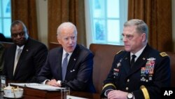 President Biden meets with Secretary of Defense Lloyd Austin, left, and Chairman of the Joint Chiefs of Staff Gen. Mark Milley, and other leaders on April 20, 2022. 