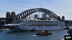 The Pacific Explorer makes its way to dock at the overseas passenger terminal on Sydney Harbour on April 18, 2022, as Australian authorities lifted a ban on cruise ships after relaxation in COVID-19 restrictions. 