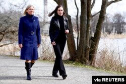 Sweden's Prime Minister Magdalena Andersson walks with Finland's Prime Minister Sanna Marin prior to a meeting, amid Russia's invasion of Ukraine, in Stockholm, Sweden, April 13, 2022.