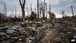 An interior ministry sapper collects unexploded shells, grenades and other devices in Hostomel, close to Kyiv, Ukraine, April 18, 2022.