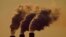 FILE - Emissions rise from the smokestacks at the Jeffrey Energy Center coal power plant as the suns sets, near Emmett, Kansas, USA. Taken 9.18.2021