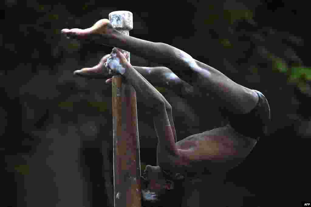 A gymnast takes part in a Mallakhamb competition in Mumbai, India.