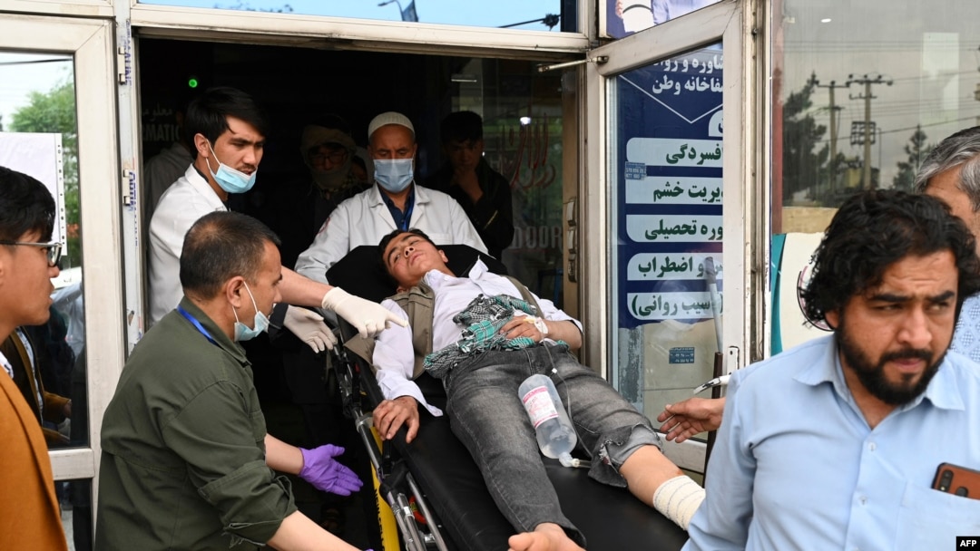 Medical staff move a wounded youth on a stretcher inside a hospital in Kabul on April 19, 2022, in Kabul on Apr. 19, 2022, after two bomb blasts rocked a boys' school in a Shiite Hazara neighborhood. 