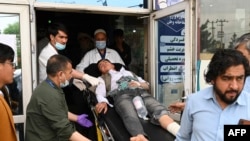 Medical staff move a wounded youth on a stretcher inside a hospital in Kabul on April 19, 2022, in Kabul on Apr. 19, 2022, after two bomb blasts rocked a boys' school in a Shiite Hazara neighborhood. 
